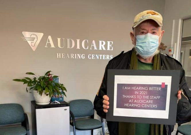 One of our esteemed patients shows off his better hearing achievement