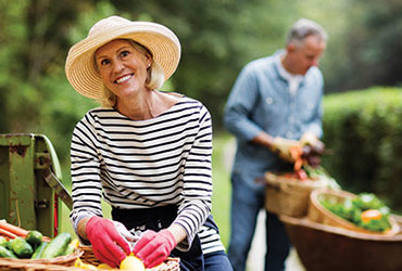 An older woman works in her garden after having her hearing tested